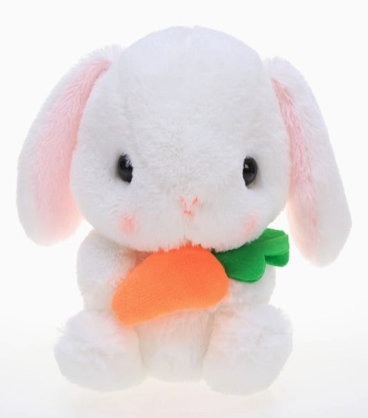 A wicker Easter basket with a plaid ribbon, containing various colorful candies and a plush toy resembling a chicken.