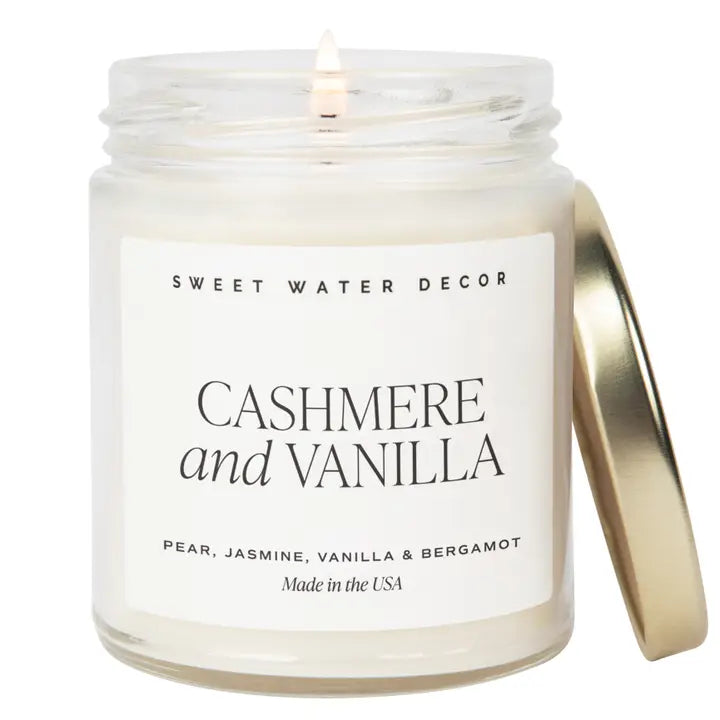 Candle in a jar labeled 'Cashmere and Vanilla' by Sweet Water Decor on a white background