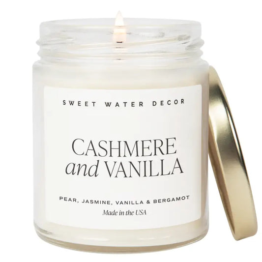 Candle in a jar labeled 'Cashmere and Vanilla' by Sweet Water Decor on a white background