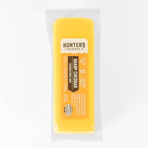 Block of sharp cheddar cheese in a clear plastic wrap with 'Hunter's Reserve' branding.