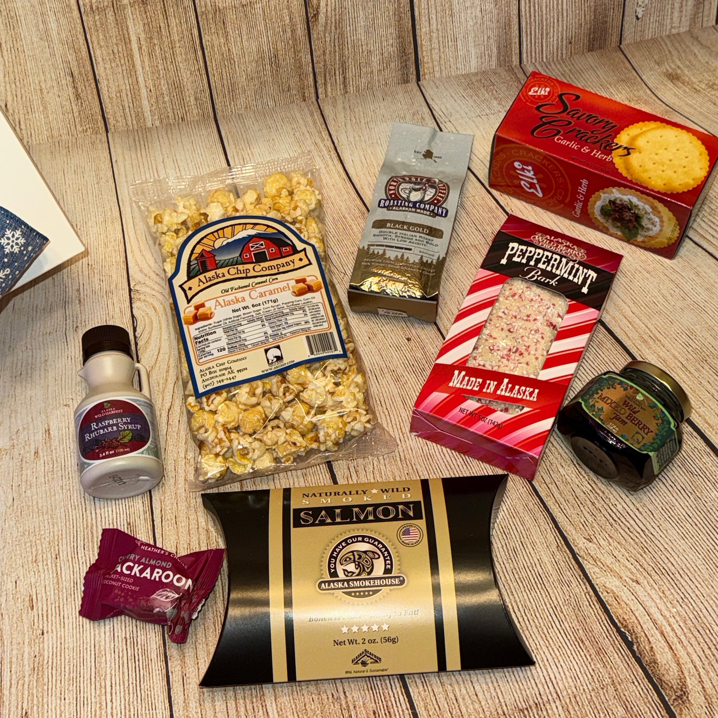 Assorted food items including popcorn, cookies, and salmon on a wooden surface.