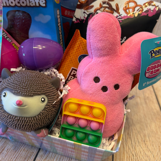 Peep Peep Easter Basket - Pink features a plush bunny, rainbow Pop-It, squishy hedgehog, Easter eggs, and assorted candies for festive fun.