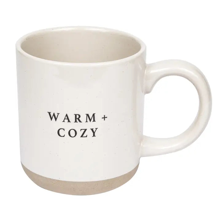 White mug with 'WARM + COZY' text on a white background
