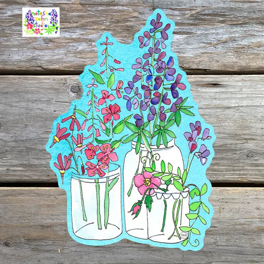 A sticker featuring a colorful illustration of flowers in jars against a blue background, placed on a wooden surface.
