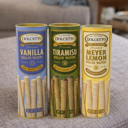 Three tubes of Dolcetto gourmet cookies with different flavors on a surface.