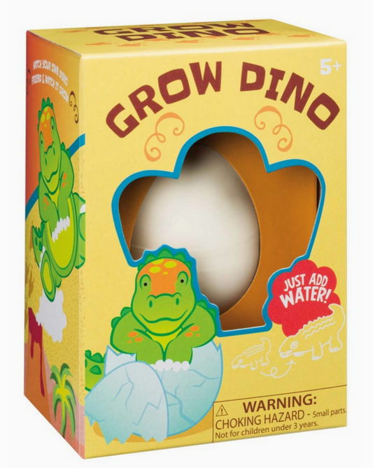 Packaging for 'Grow Dino' toy featuring a cartoon dinosaur and an egg, with the text 'JUST ADDED WATER!' and warnings about choking hazard and small parts.