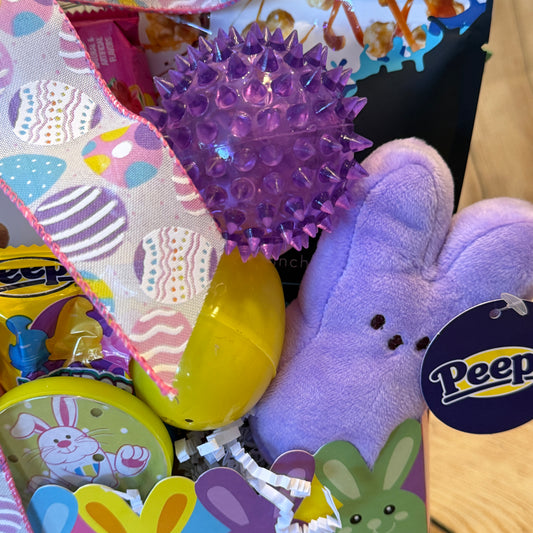 Easter Joy Gift Basket featuring pastel fabric, plush Peep bunny, yellow eggs, Peeps candy, spiky ball, and bunny tin, nestled in colorful shreds.