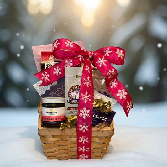 Gift basket with a red ribbon on a snowy background