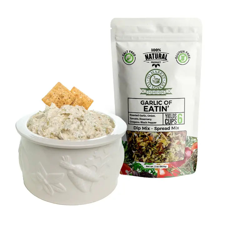 Garlic of Eatin' dip mix with a bowl of dip and crackers on a white background