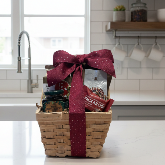Gold Rush Alaska Gift Basket with jam, coffee, Packaroo snack bar, and gourmet treats, elegantly arranged on a kitchen countertop, perfect for gifting.