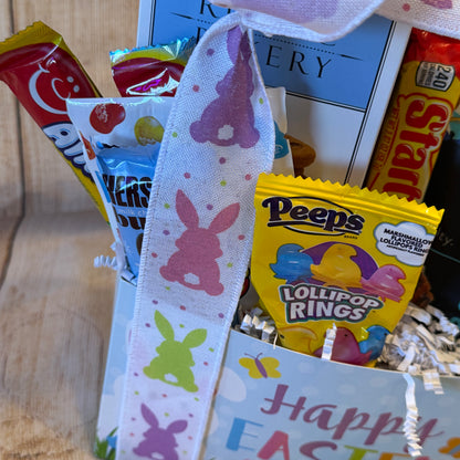 Happy Easter Gift Basket with Peeps Lollipop Rings, Starburst, Hershey’s chocolate, and playful toys, all in a pastel bunny-decorated container.