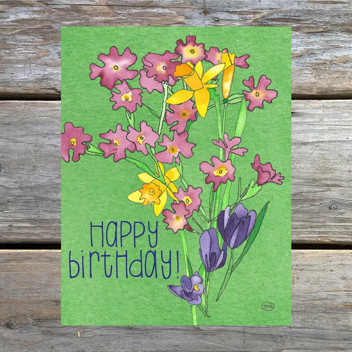 A colorful note card featuring a watercolor illustration of flowers and a happy birthday message