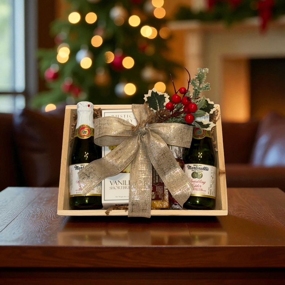 Gift basket with bottles and a bow in front of a Christmas tree