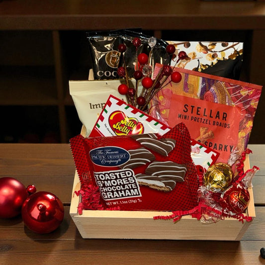 Gift basket with snacks and treats on a wooden surface