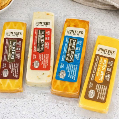 Four packages of Hunter's Reserve cheese on a gray surface