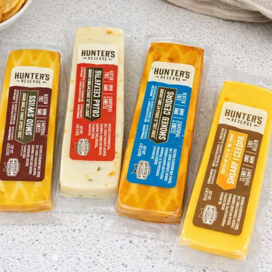 Four packages of Hunter's Reserve cheese on a gray surface