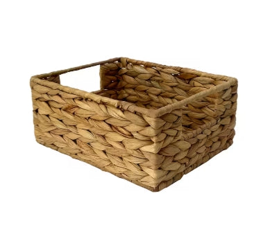 A rectangular woven hyacinth basket with handles on the sides.