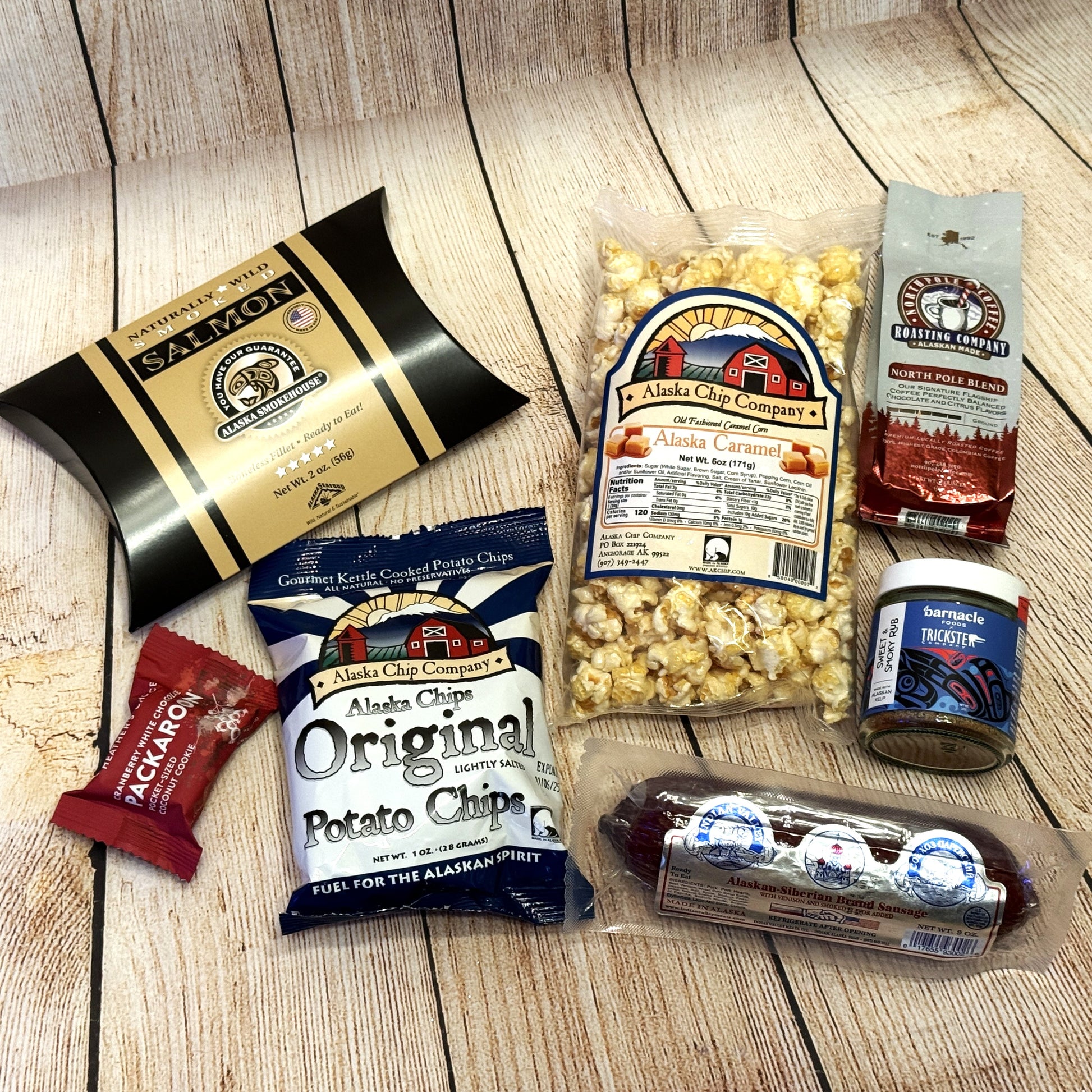 Gifted Basket- Juneau-gift-basket: assorted snacks, including chips, popcorn, and a sausage