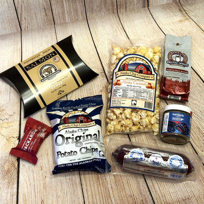 Gifted Basket- Juneau-gift-basket: assorted snacks, including chips, popcorn, and a sausage