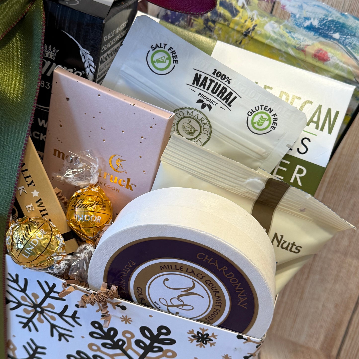 Assorted snacks and candies in a decorative box with visible branding.