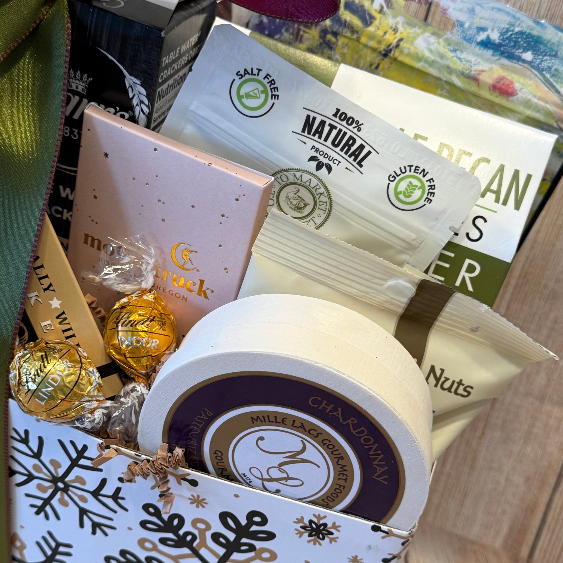 Assorted snacks and candies in a decorative box with visible branding.