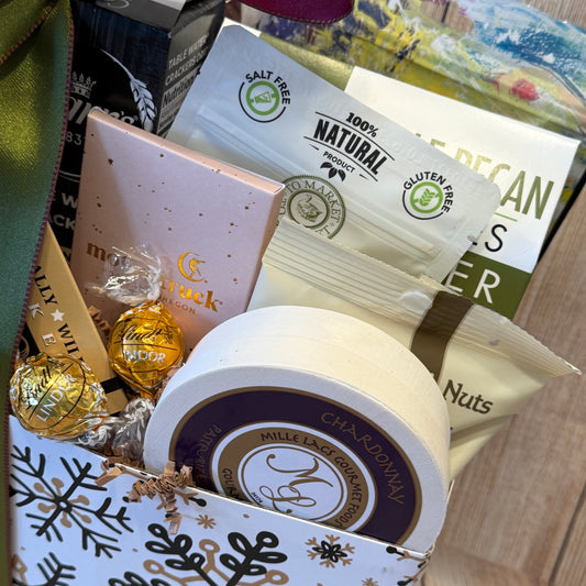 Assorted snacks and candies in a decorative box with visible branding.