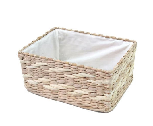 A beige natural woven basket with a white lined interior.