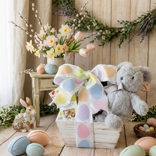 The Little Bunny Easter Gift Basket: rustic box with plush bunny, cherry chocolates, fabric eggs, bird’s nest, ceramic rabbit, and spring flowers.
