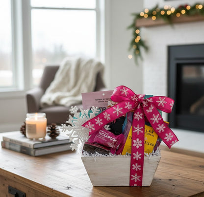 Gift basket with a pink bow on a wooden coffee table in a cozy living room.