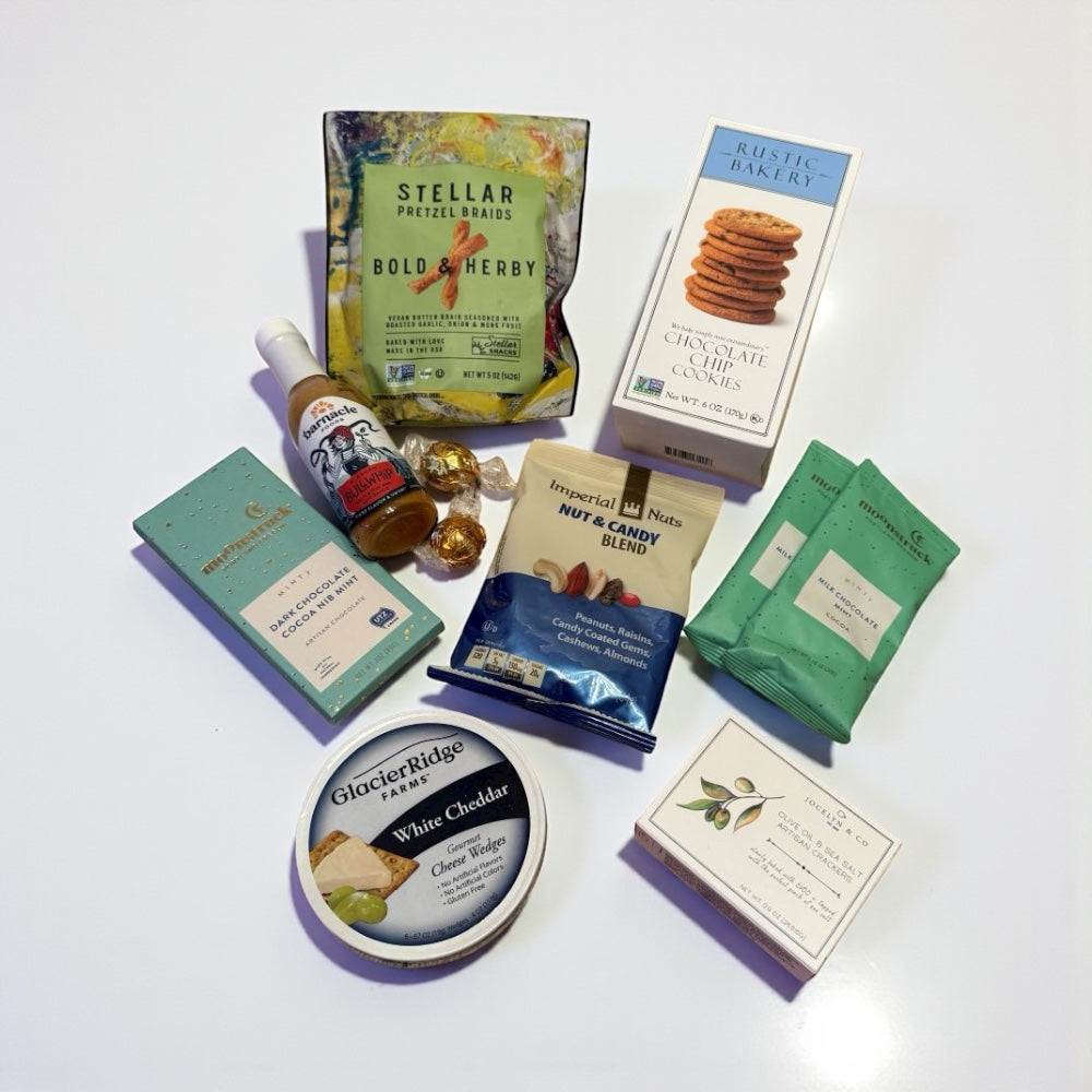 Assorted snacks and treats including Stellar pretzel bars, Glacier Ridge white chocolate, and other packaged goods on a white background.