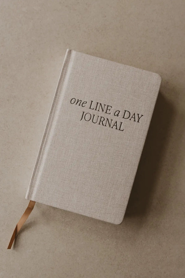 Beige journal with 'one LINE a DAY JOURNAL' text on a beige background