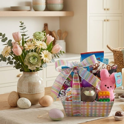 Peep, Peep Easter Basket - Pink featuring a pastel-plaid basket with Peeps bunny, pop-it toy, plush hedgehog, candy assortments, and decorative eggs, styled on a tabletop.