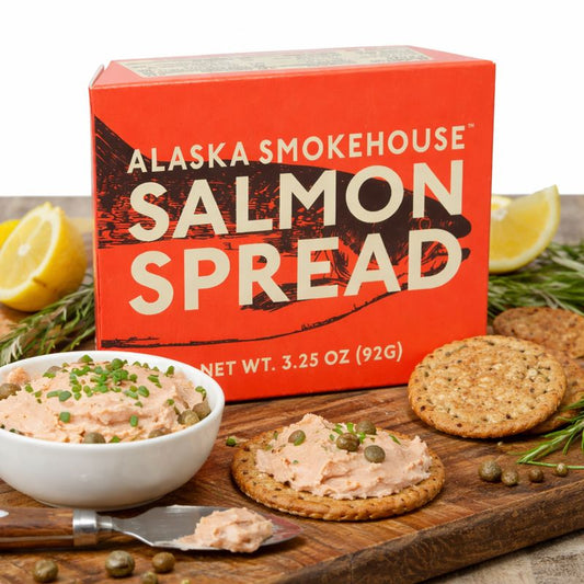 Alaska Smokehouse Salmon Spread with crackers and lemon on a wooden board