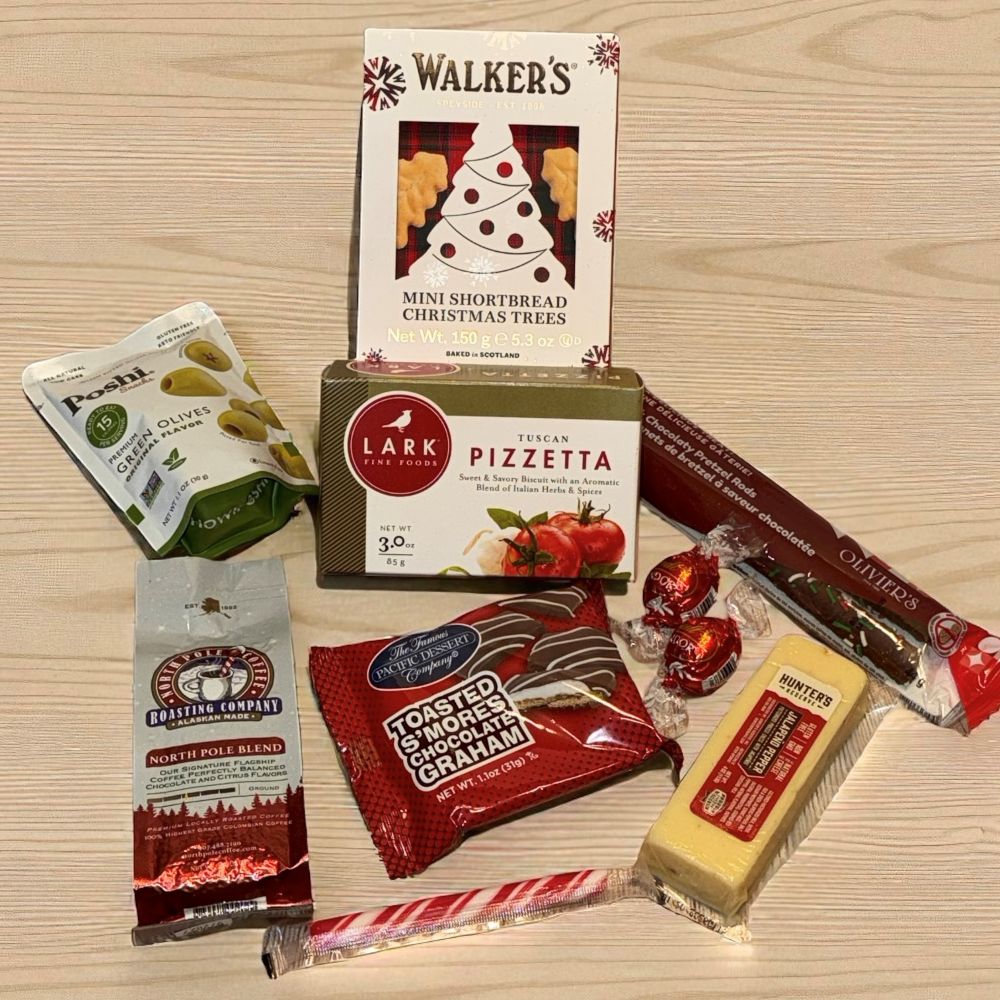 Assorted food products including Walkers shortbread, Lark pizzette, and other snacks on a wooden surface.