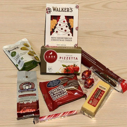 Assorted food products including Walkers shortbread, Lark pizzette, and other snacks on a wooden surface.