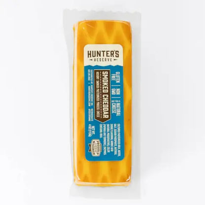 Block of smoked cheddar cheese with 'Hunter's Reserve' label on a white background