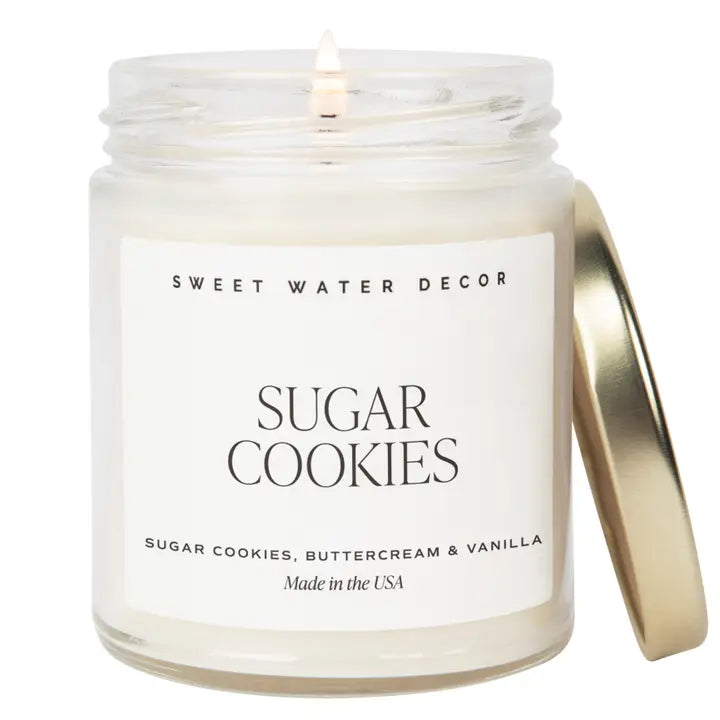 Candle in a jar labeled 'Sweet Water Decor Sugar Cookies' on a white background