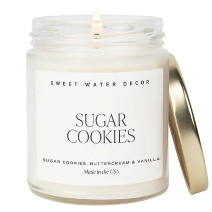Candle in a jar labeled 'Sweet Water Decor Sugar Cookies' on a white background