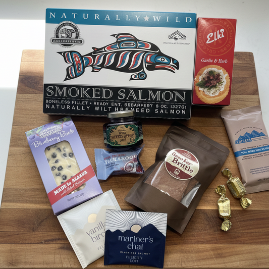 Susitna Alaskan Gift Crate featuring smoked salmon, Elk crispbreads, salted caramels, nut brittle, fruit candy, berry preserve, blueberry bark, and two tea sachets.