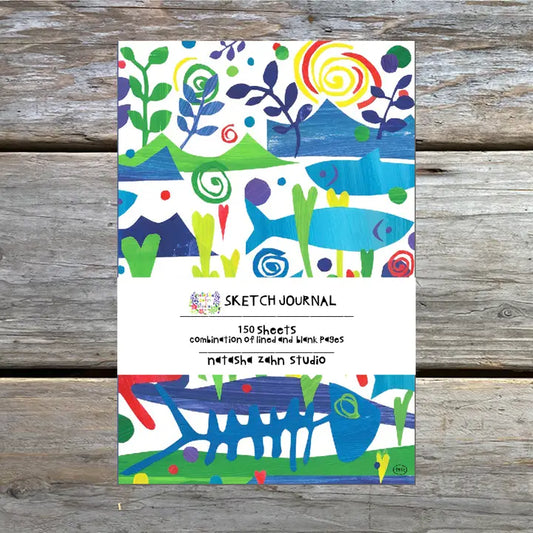 A colorful journal with an underwater theme, featuring fish and seaweed on the cover, labeled as 'Sketch Journal' with '150 sheets' and 'Natasha Zahn Studio'.