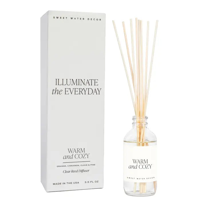 Diffuser with reeds and packaging labeled 'Sweet Water Decor' on a white background. Warm and Cozy Scent.