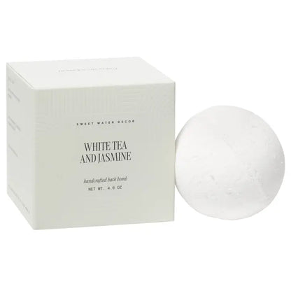 White tea and jasmine bath bomb with packaging on a white background